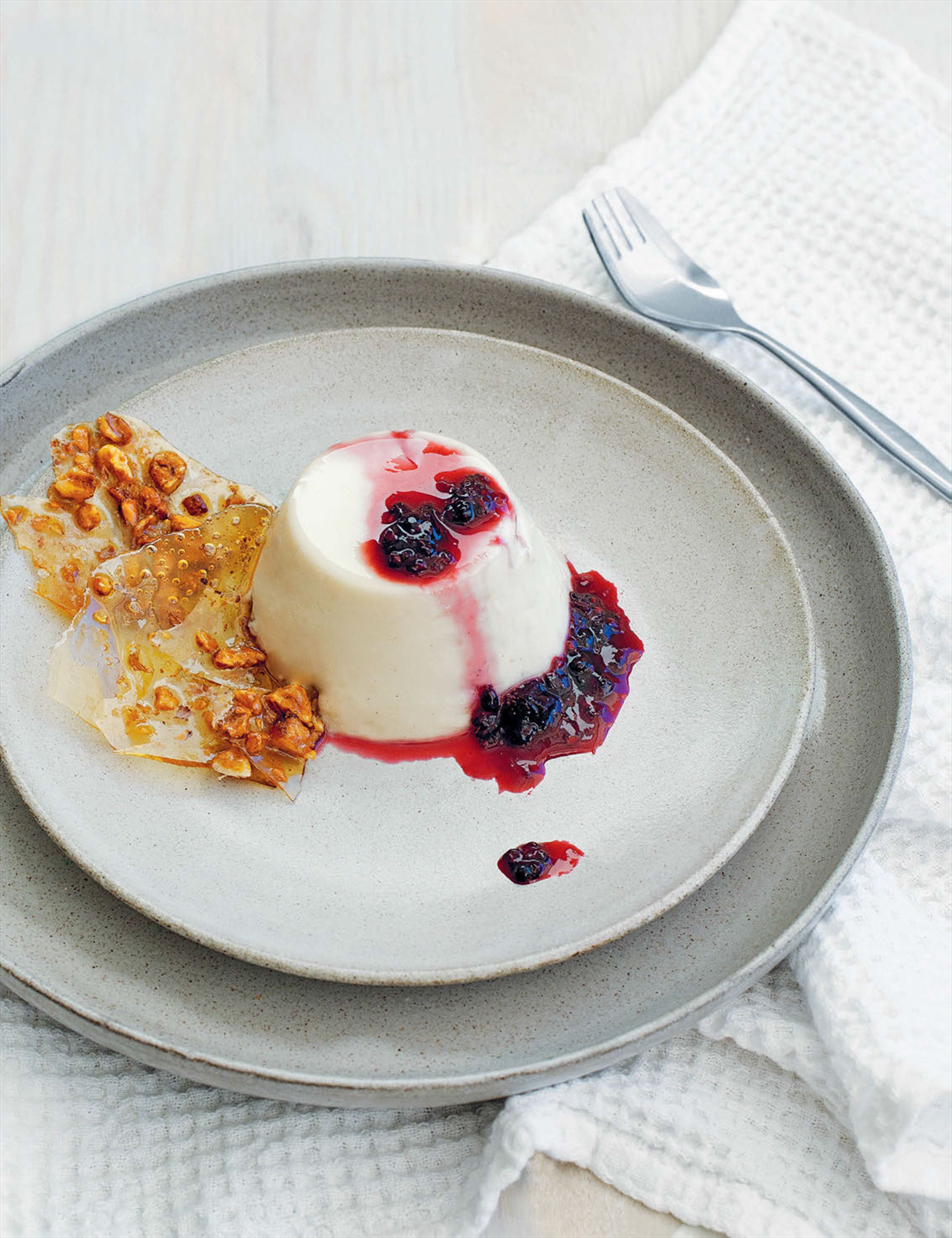 Panna cotta with almond brittle and berry sauce