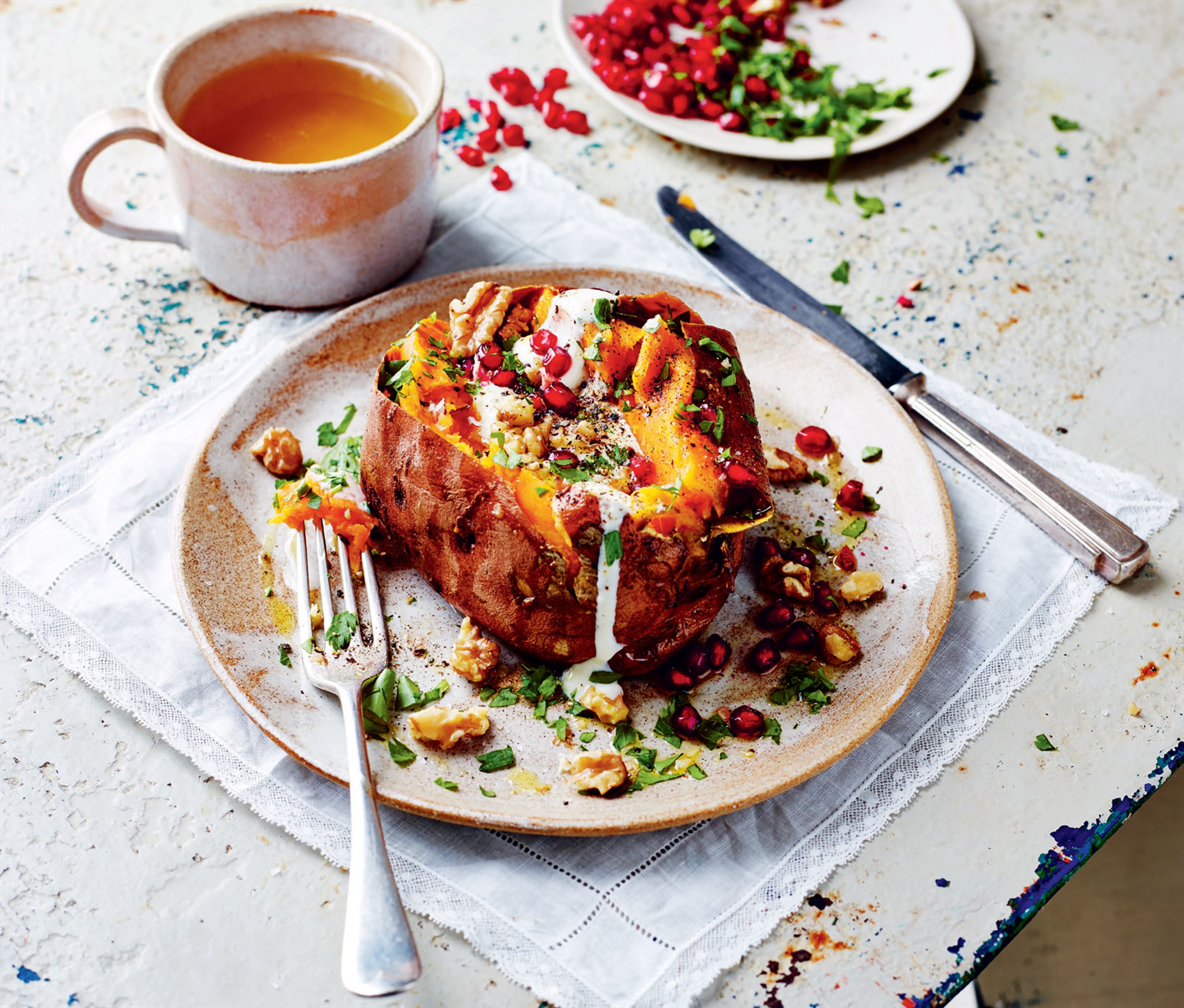 Sweet jacket potatoes with yoghurt, pomegranate, and toasted walnuts
