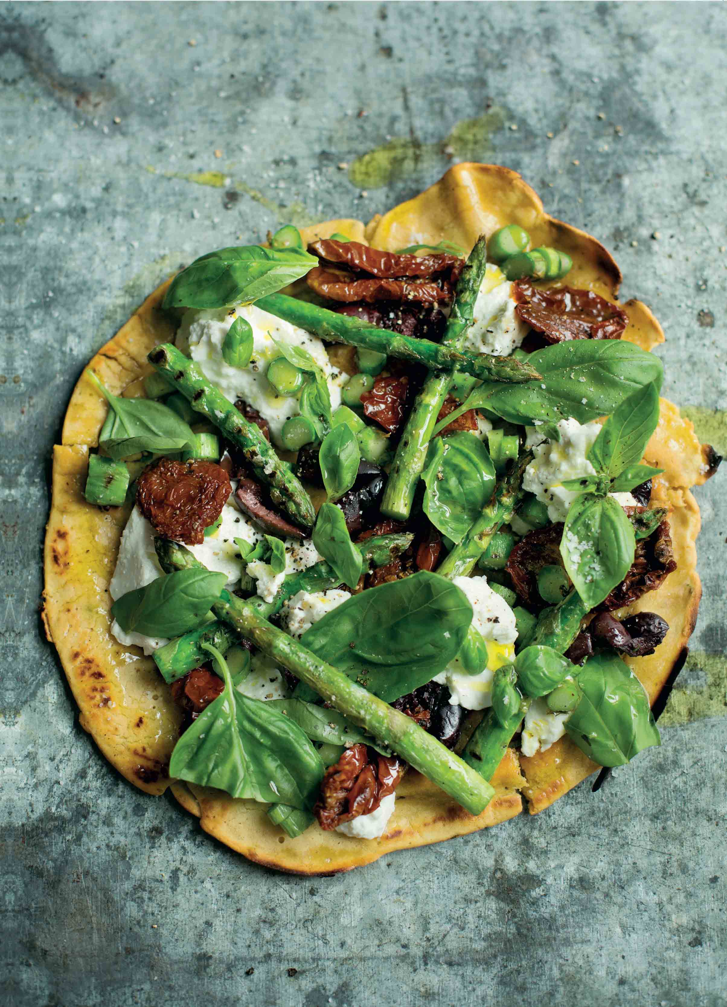 Socca pizza with char-grilled asparagus, olives and ricotta