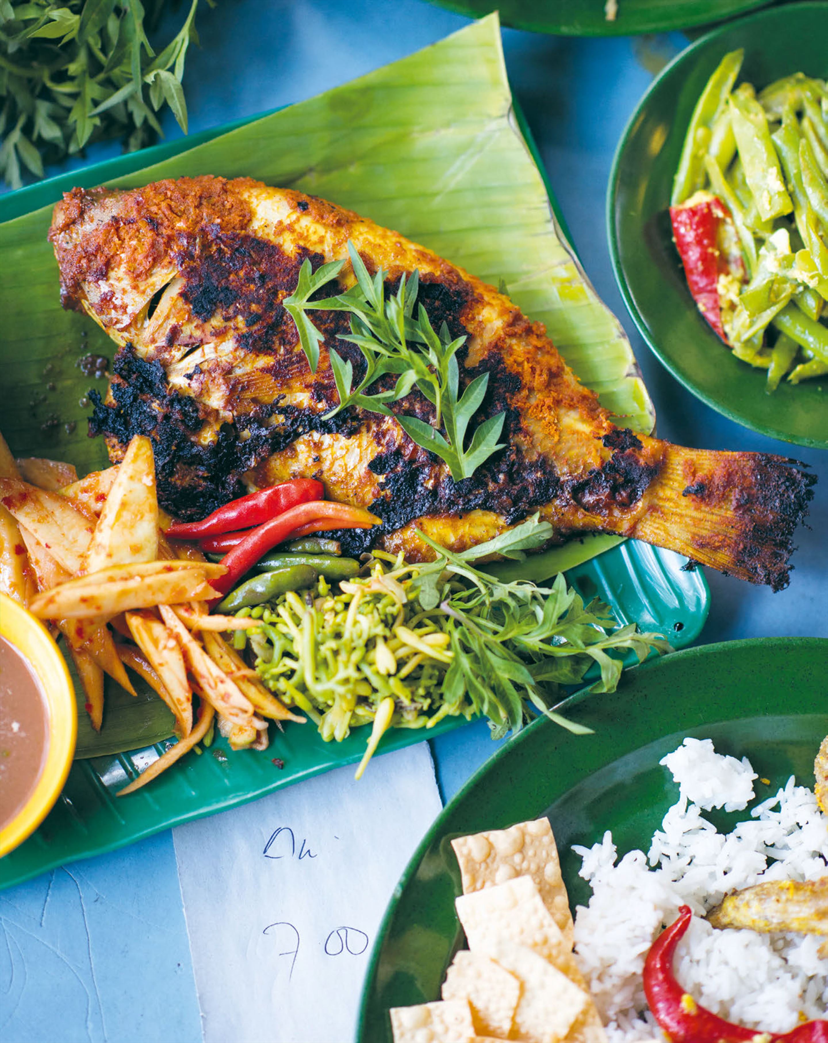Grilled fish & herbs wrapped in banana leaf