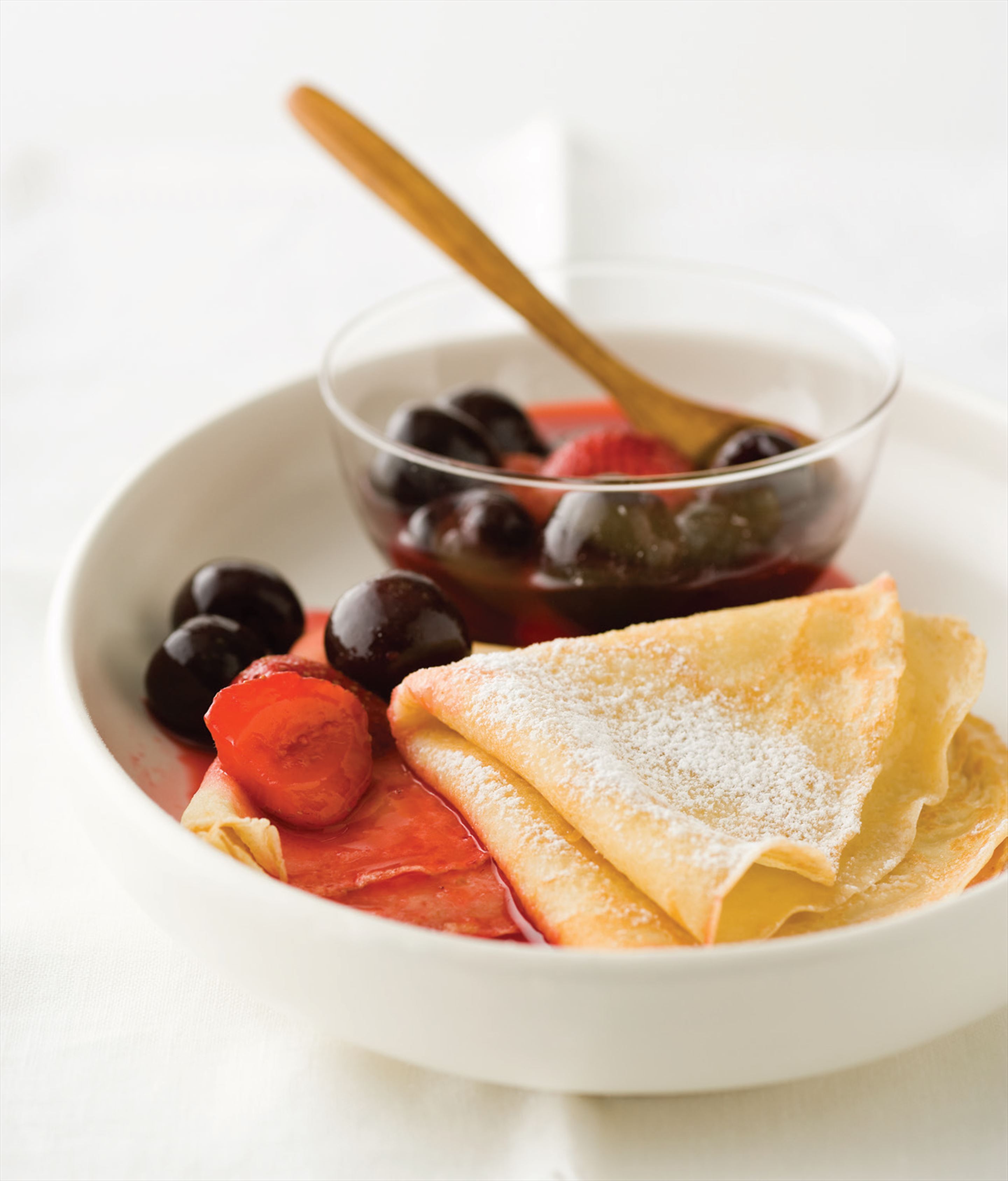 French crêpes with poached cherries and berries