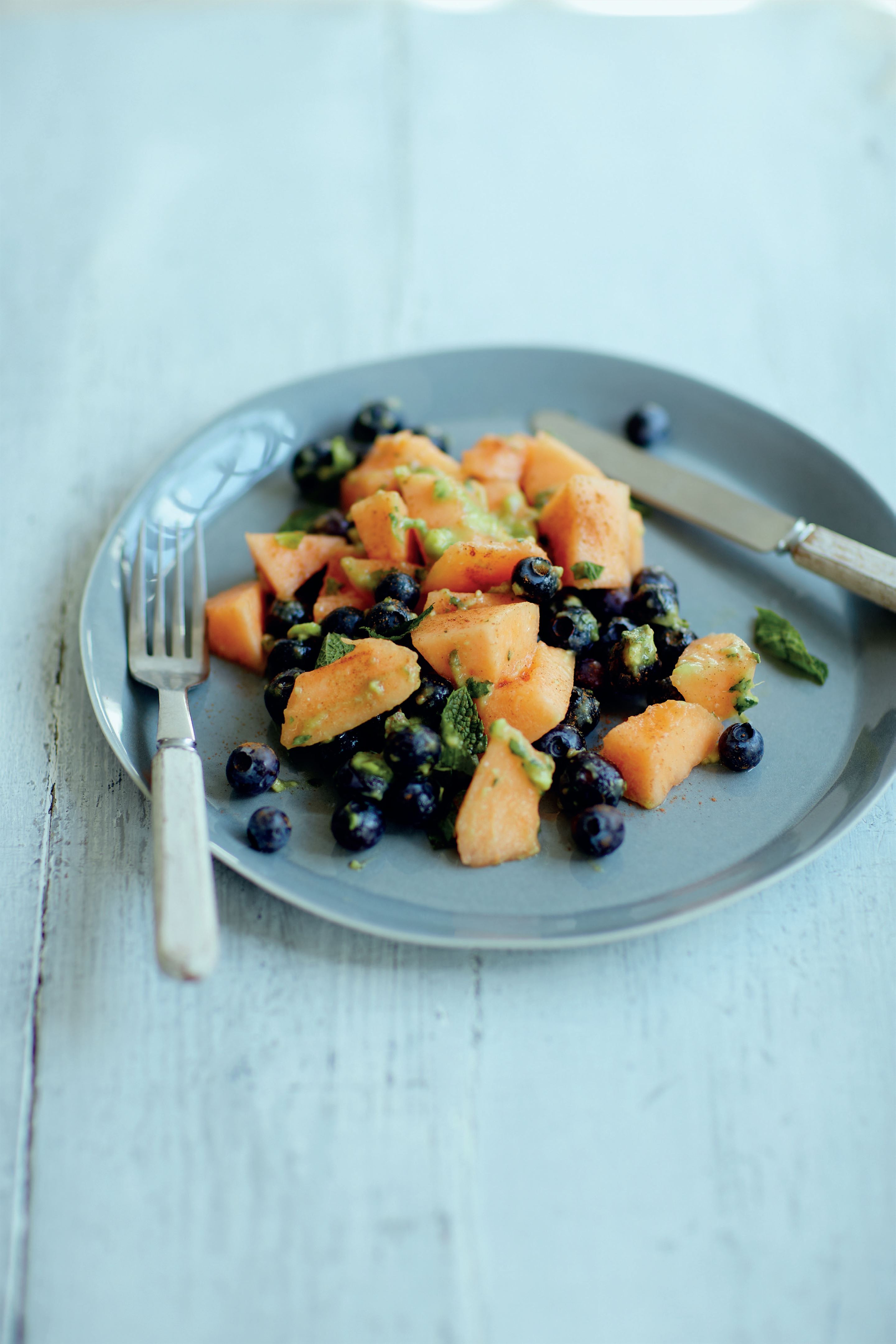 Cantaloupe melon and blueberry salad with avocado lime dressing
