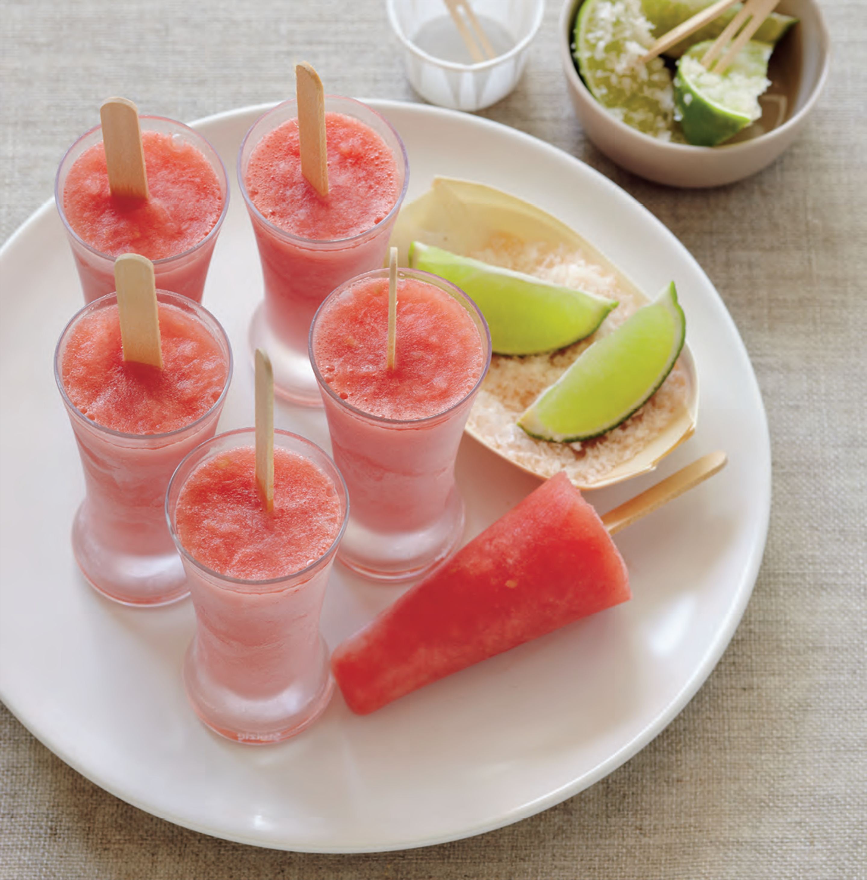 Watermelon margarita pops with sweet and salty lime wedges