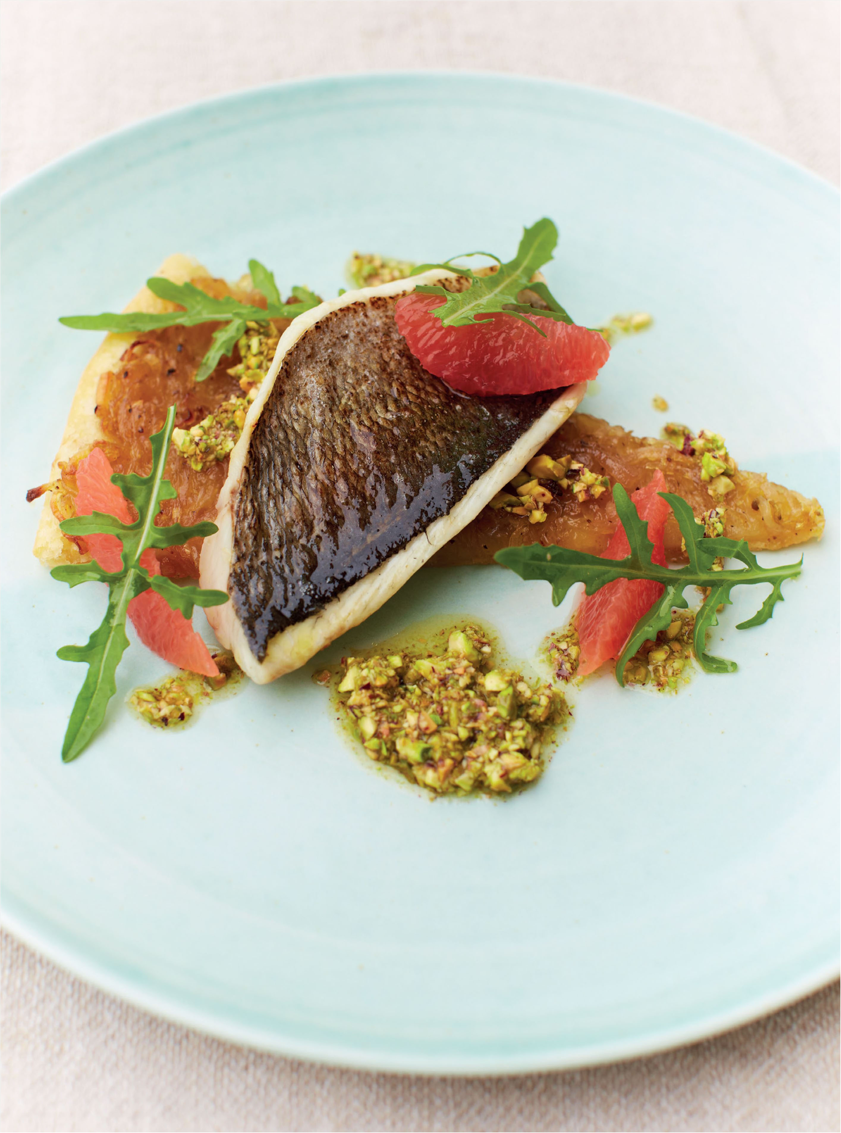 Bream with chicory tart, pink grapefruit and pistachio dressing