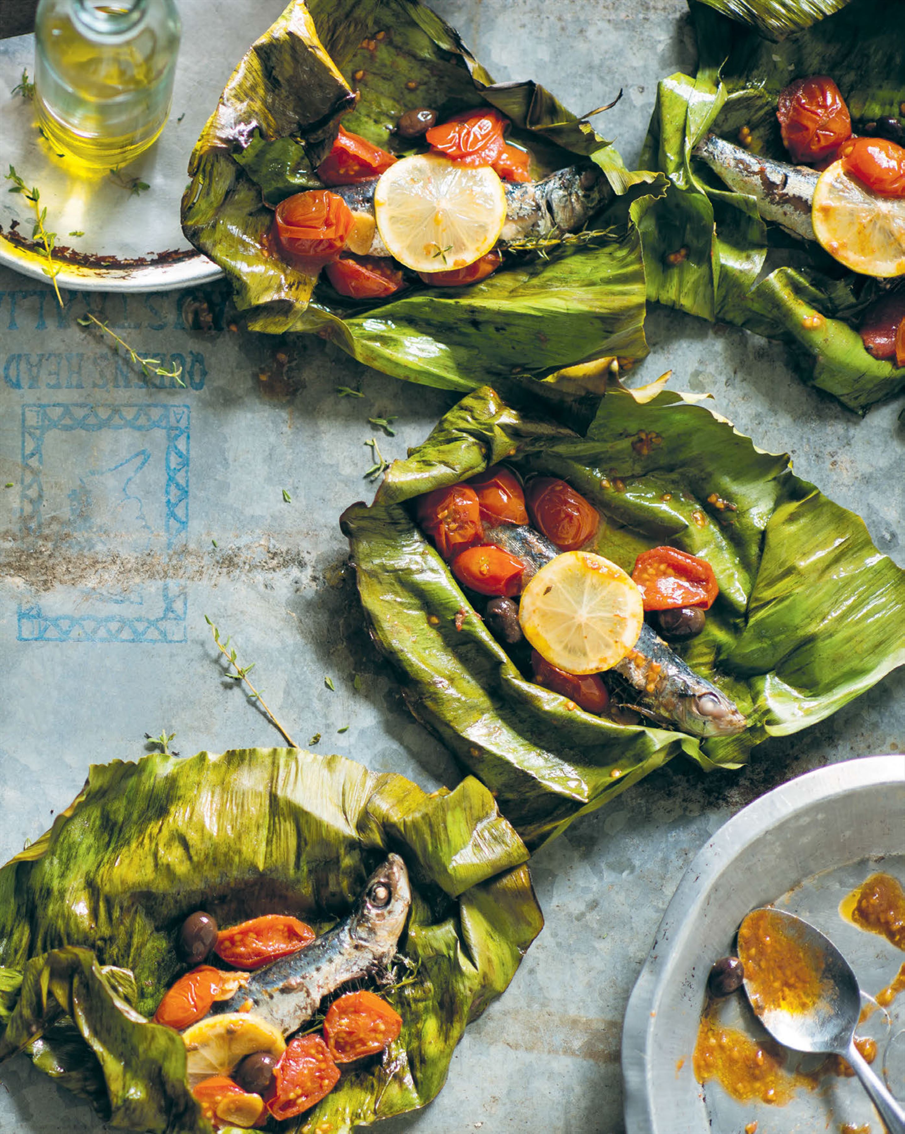 Sardines roasted in banana leaves with olives & cherry tomatoes